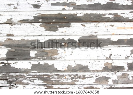 Wood panel texture with white chipping and peeling paint Royalty-Free Stock Photo #1607649658