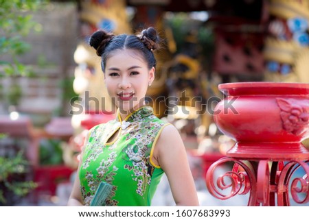 Portrait: Chinese teenage girl wearing traditional Chinese traditional costume, happy smile in Chinese New Year festival
