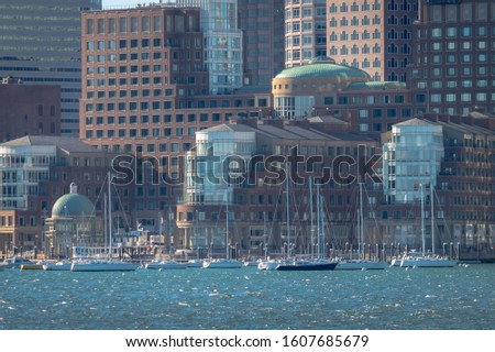 Remaining sailboats left in the water to endure the winter, near a hotel on Boston Harbor.