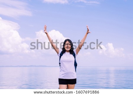 Happy woman standing with open hands at sea,Enjoying in Nature,Freedom concept