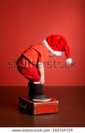 little cute boy with christmas suitcase