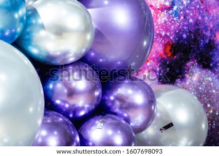Many colorful balloons decorated wall as background. Galaxy concept
