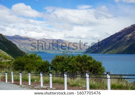 Lake, mountains, trees, sky, clouds in New Zealand.Mountain road