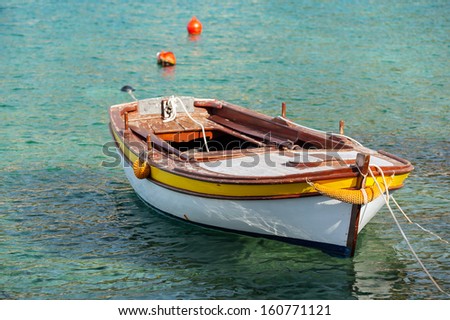 Wooden fishing boat floats moored in Adriatic sea water, Montenegro