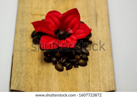 A stack of coffee with beautiful red flowers on it. Valentine's Day picture concept with white background.