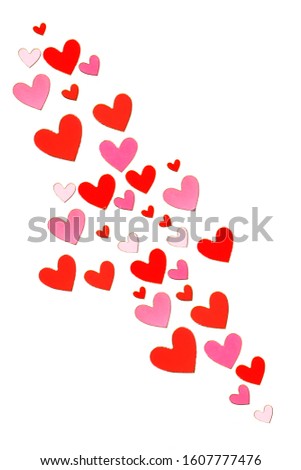 holiday background of tiny red paper hearts on a white 