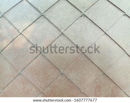 The background is made of brown concrete with patterns.