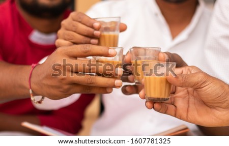 Close up of hands cheers Tea glasses - concept showing group of friends enjoying morning Tea by cheering at Hotel. Royalty-Free Stock Photo #1607781325