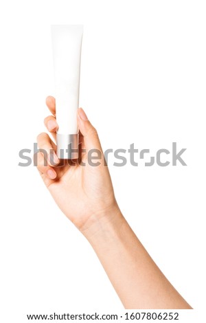 woman hand hold a blank cosmetic container isolated on white.