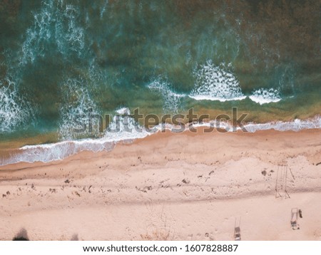 Top view aerial photo from drone of an stunning beautiful sandy landscape beach with turquoise water with tree. Beautiful Sand beach with turquoise water, aerial UAV drone shot.