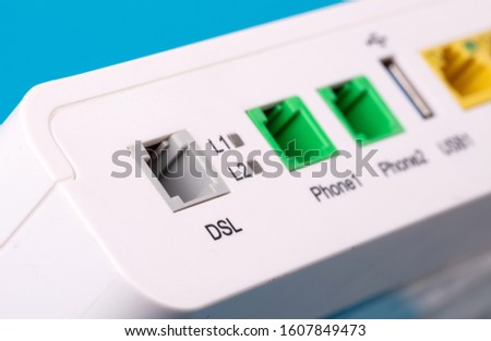 Desktop Home ADSL modem on a blue background back view, selective focus Royalty-Free Stock Photo #1607849473