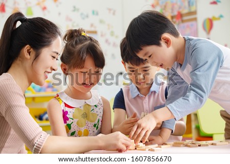 Kindergarten teachers and the children Royalty-Free Stock Photo #1607856670