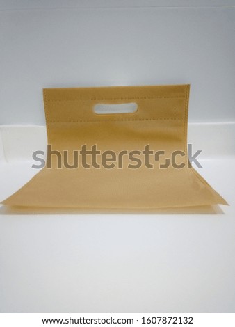 brown color fabric bag isolated on white table 