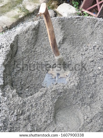 There is a hoe on the sand. 