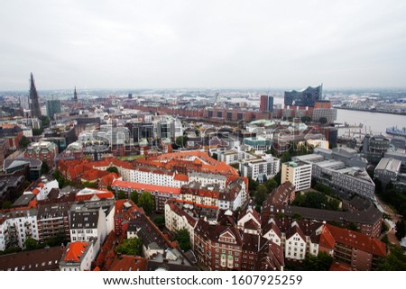View of the city of Hamburg from a height. City buildings, houses, streets and the Elbe river.
