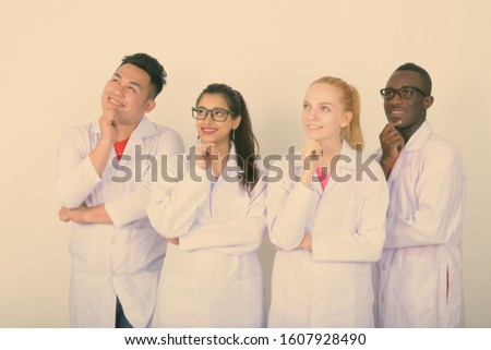 Diverse multi ethnic group of happy doctors thinking together