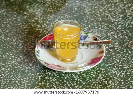 A picture of fresh Mekong honey lemon tea on stone table.