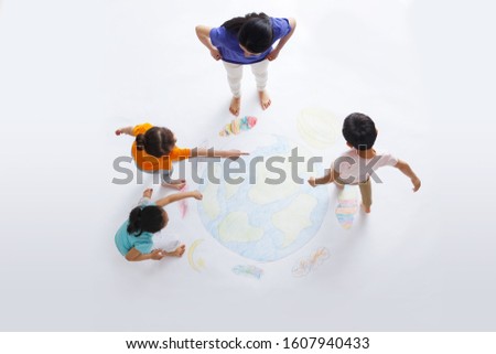 Kindergarten teacher with the children to draw Royalty-Free Stock Photo #1607940433