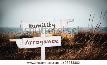 Street Sign the Direction Way to Humility versus Arrogance Royalty-Free Stock Photo #1607953882