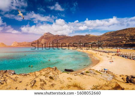 Panorama of turquoise beach Falasarna (Falassarna) in Crete with seagulls flying over, Greece. View of famous paradise sandy deep turquoise beach of Falasarna (Phalasarna), Crete island, Greece. Royalty-Free Stock Photo #1608052660
