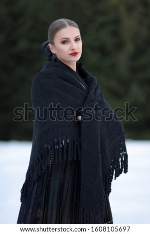 Young beautiful slovak woman in traditional costume

in winter