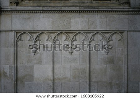 Decorative Gothic facade wall with Gothic stone relief ornaments. Wall detail