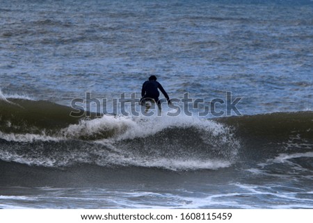 surfing the big waves in the mediterranean sea in Israel