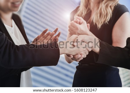 business people shake hands to make a business proposal agreement on city and clap clap background