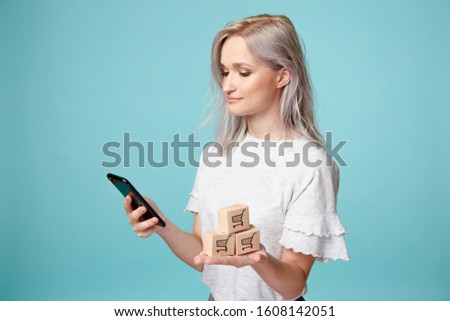 Female with phone and picture of shopping bascket. Shopping online concept.
