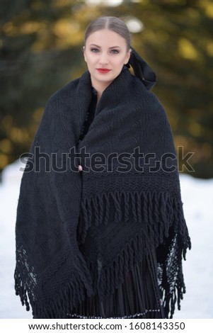 Young beautiful slovak woman in traditional costume in winter
