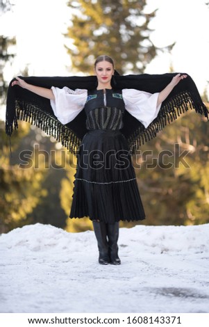 Young beautiful slovak woman in traditional costume in winter