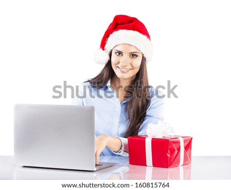 Beautiful woman is working in office with christmas hat