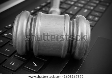 Judge gavel on laptop computer keyboard, cyber law and crimes concept