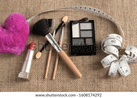 Body tape measure with cosmetics,make up and brushes for beauty. Conceptual
