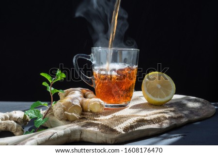 health, traditional medicine and ethnoscience concept.ginger tea on rustic background Royalty-Free Stock Photo #1608176470