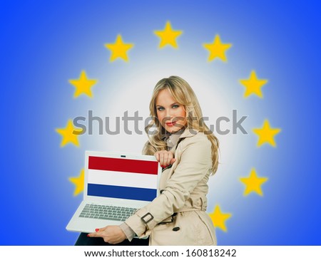  woman holding laptop with netherlands flag on the screen and european union stars in the background