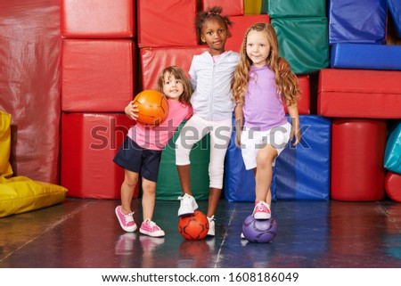 Children play together in the gym from kindergarten with balls