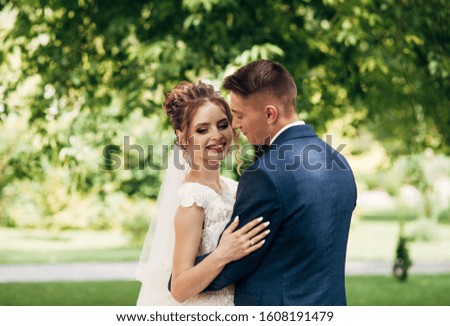 bride and groom on a background of greenery