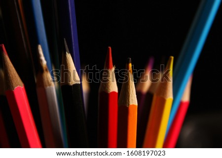 Wooden colored pencil on black background
