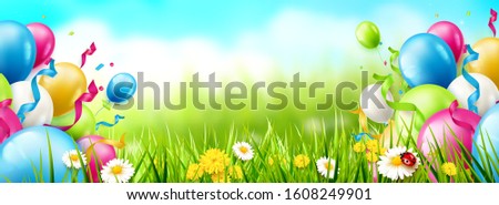 Colorful balloons and confetti on spring landscape. Place for text.