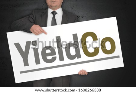 Businessman holds YieldCo signboard concept.