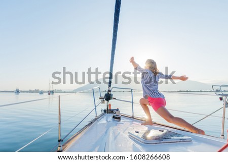 Beautiful is practicing yoga on the deck of the yacht boat