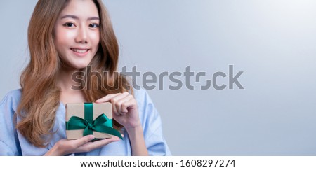 business healthy insurance beautiful asian female in hospital uniform smile with hand show present box ideas for happy insurance package and promotion with hospital blur background