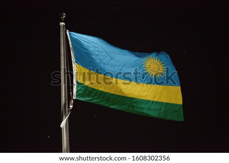 Rwanda flag blowing in the wind at night