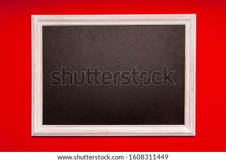 White photo frame with black middle on a red background. Space for text, copy space.