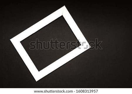White photo frame on a black background. Space for text, copy space.