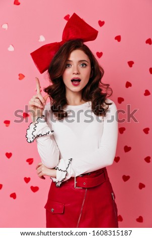 Studio shot of graceful curly woman in white shirt. Photo of romantic female model posing in valentine's day.