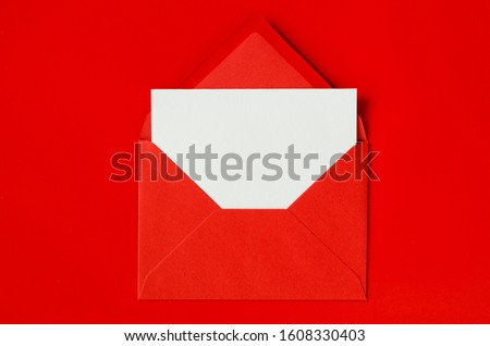 Red envelope with blank white paper. Valentine's day background. Mockup of love letter. Royalty-Free Stock Photo #1608330403