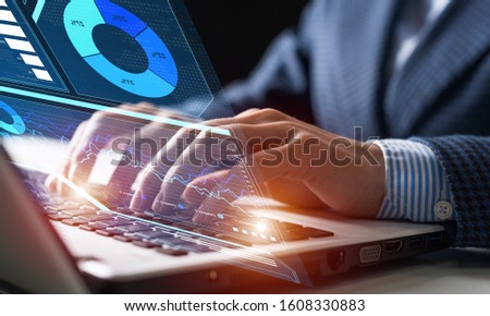 Businessman works with financial data. Futuristic 3d interface above laptop computer. Interactive business analytics and digital data visualization concept. Global banking and investment