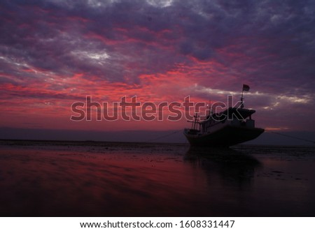 Beautifful Red Sunset with the boat in Barrang Lompo Island. The Picture has Perfect Touch to eye